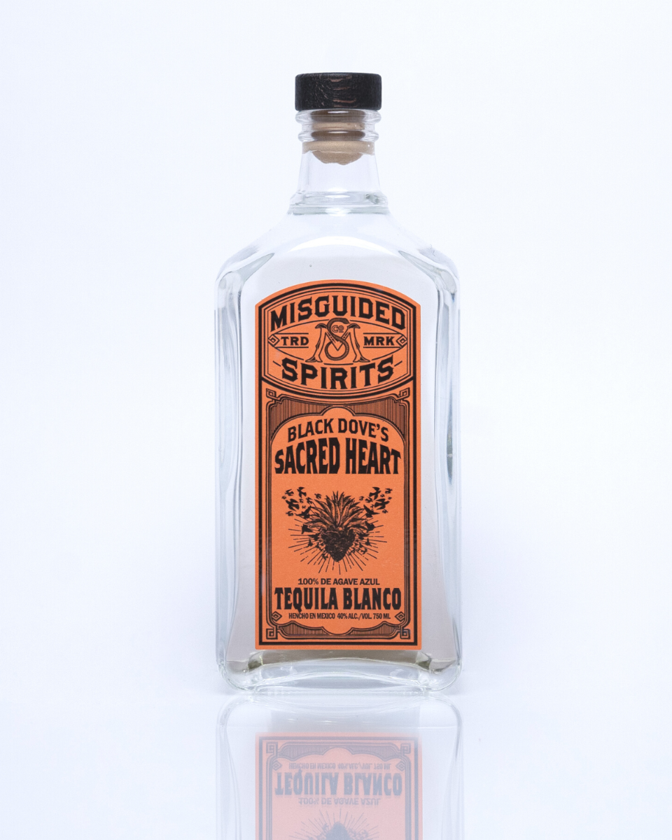 750 ml bottle of Misguided Spirits Black Dove's Sacred Heart Tequila Blanco with an orange label and crystal clear liquid in the bottle. 