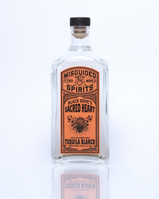 750 ml bottle of Misguided Spirits Black Dove's Sacred Heart Tequila Blanco with an orange label and crystal clear liquid in the bottle. 